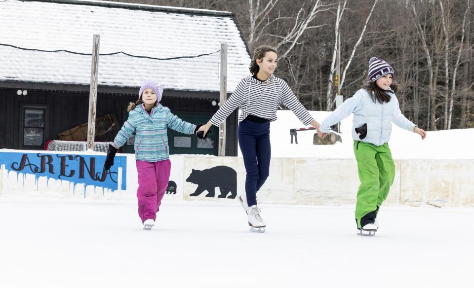 three girls ice skating