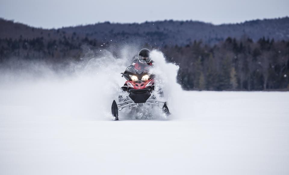 a snowmobile riding in puffy snow