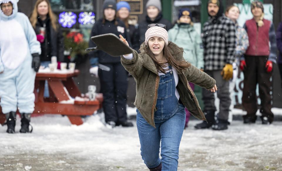 A woman tossing a frying pan in the frying pan toss