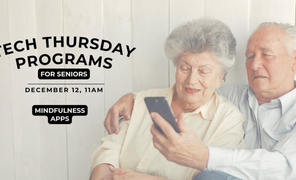 An elderly couple looking at a cell phone together