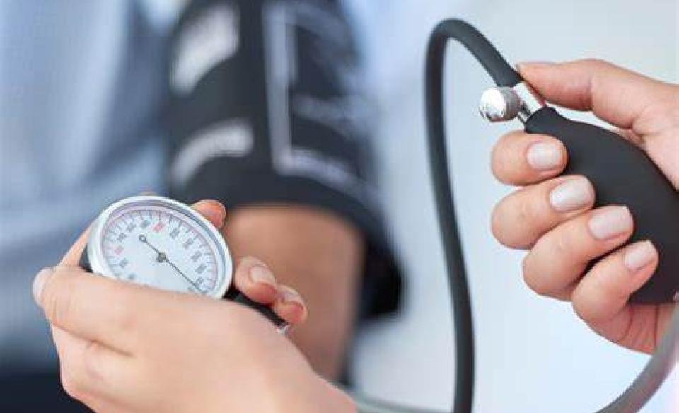 a nurse taking the blood pressure of a patient