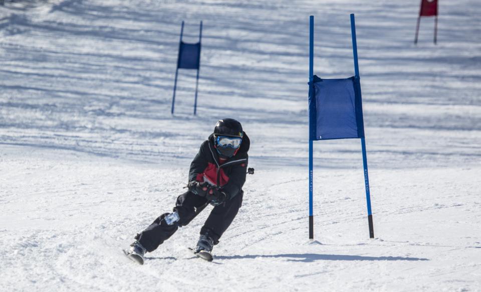 a skiier weaving around a flag marker