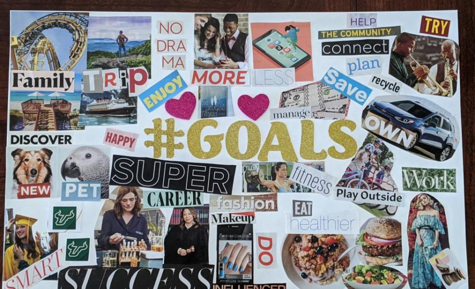 A vision board made with magazine cut outs of pictures and words/ phrases to describe their goals for the year