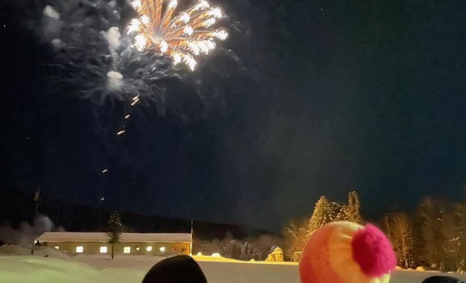 two kids watching the fireworks over the Morehouse rec center