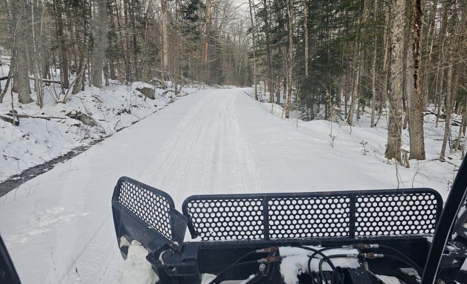 Looking out the front window of the groomer as it goes down a trail