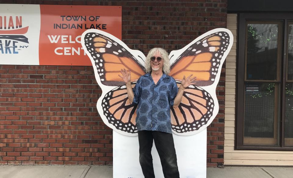 a man posing in front of the monarch photo prop