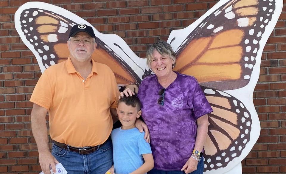 A familt posing in front of the monarch photo prop