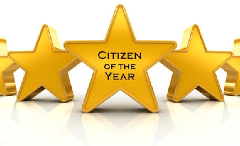 An image of a row of stars with the middle one reading Citizen of the Year on it