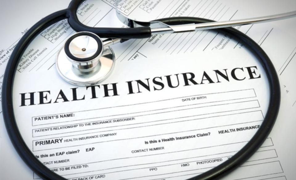 a picture of a health insurance form with a stethoscope coiled on top of it