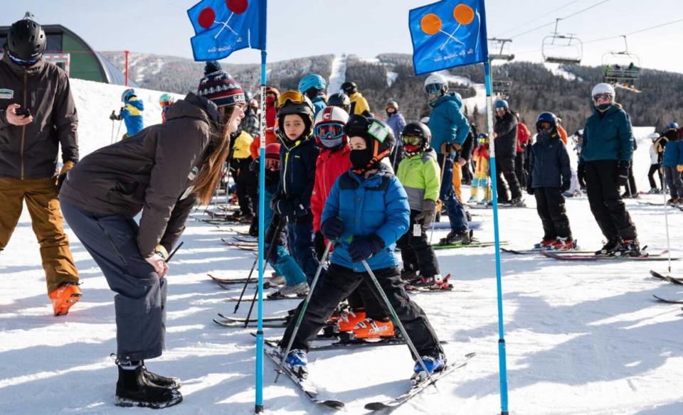 Kids lined up at the starting point of a kids downhill skiing race