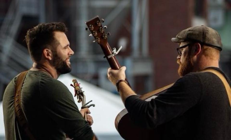 A photo of Seth and Nash performing on stage