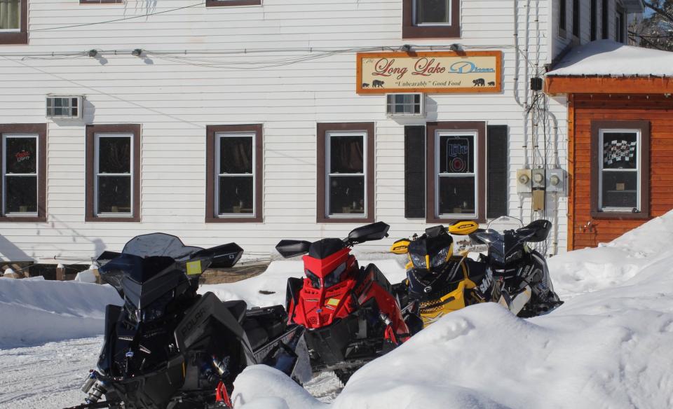 A lint of snowmobiles parked outside the Long Lake Diner