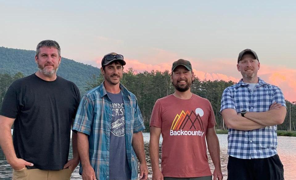 The four men who make up the band Altered Tones standing next to each other for a photo