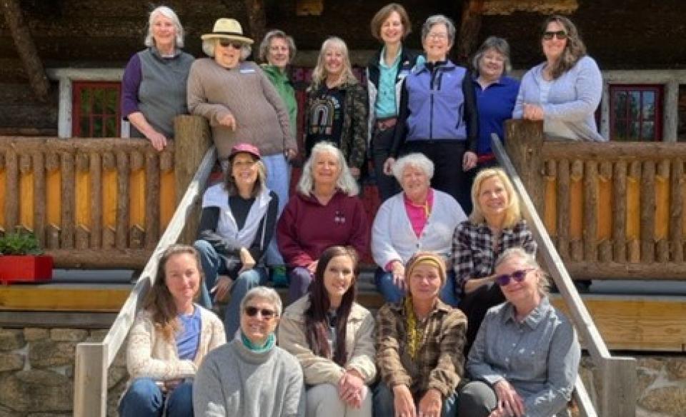 Several women on the porch of the Great Camp Sagamore for a group photo