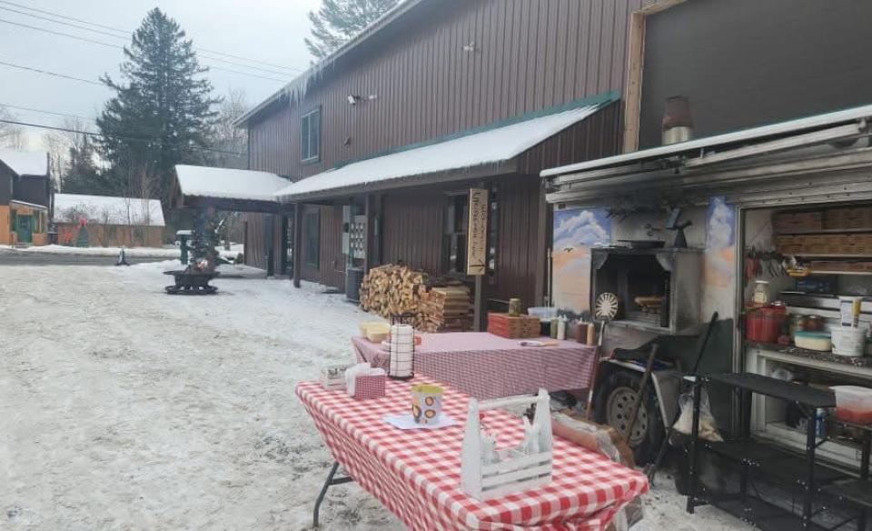Exterior photo of Axes & Irons building with the pizza truck set up out front