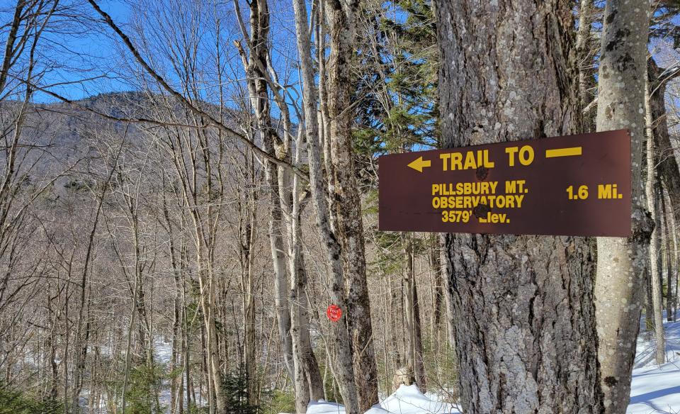 A wooden trail sign for Pillsbury Mountain