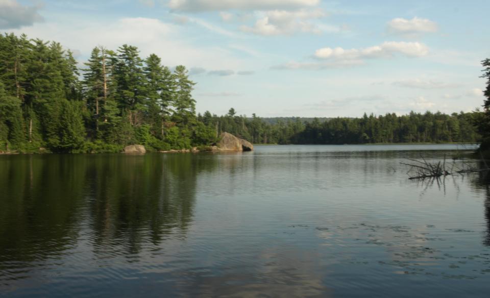 A large body of water with a rocky peninsula.