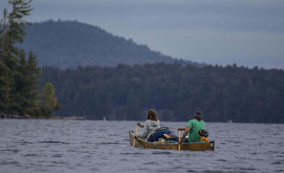 The mountains make a misty backdrop for a sunrise paddle.