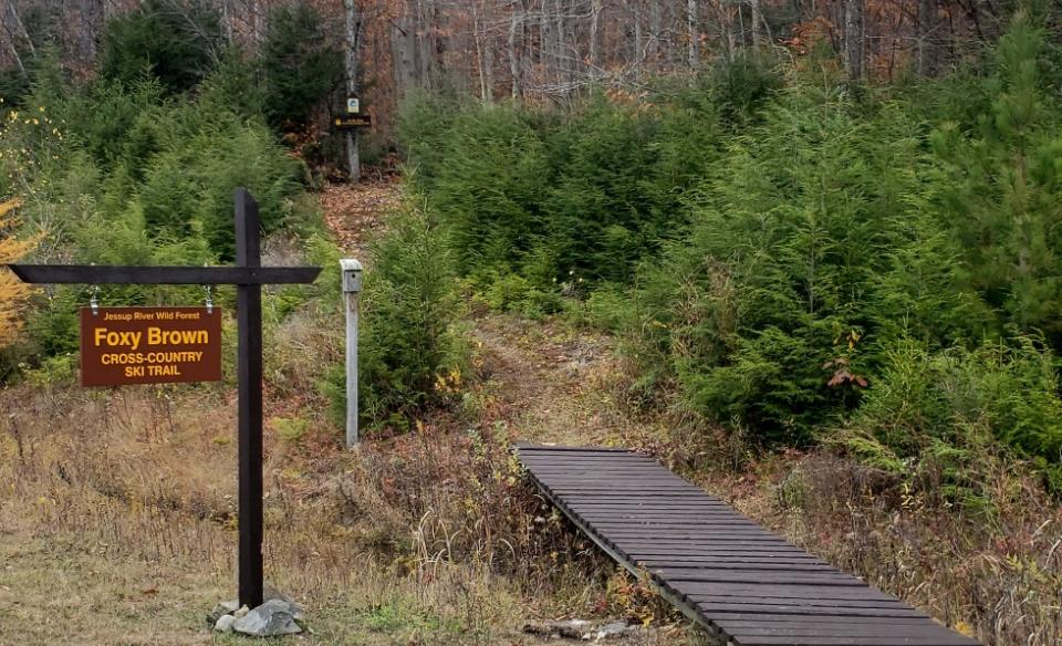 A wooden sign for the Foxey Brown ski trail