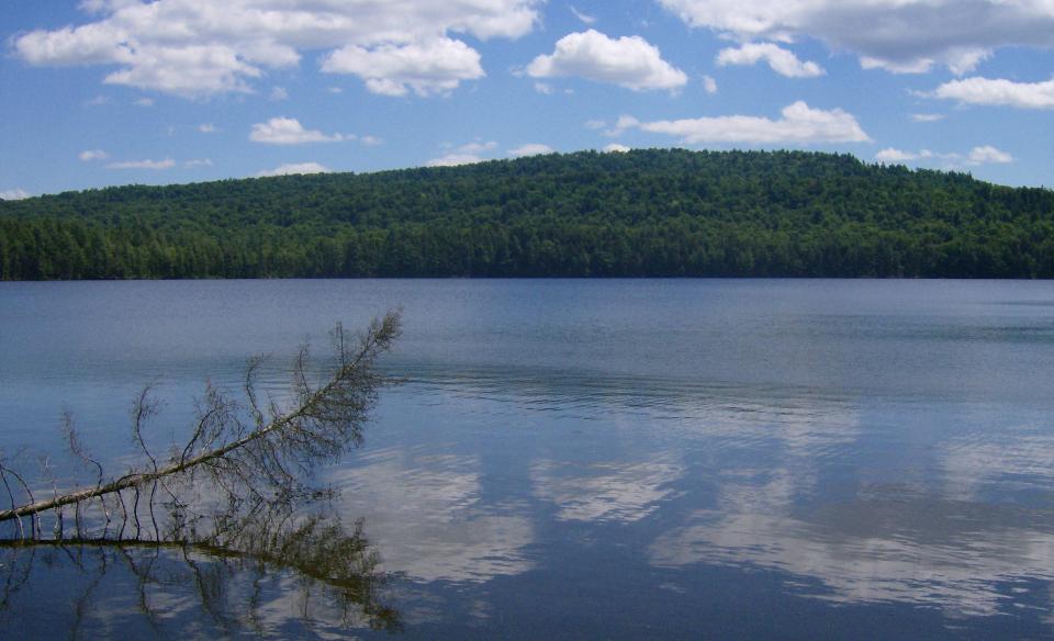 A view of a short mountain ridge from across a pond