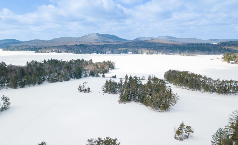 A lake iced over, dotted with islands