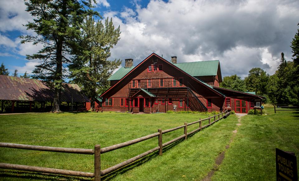 Great Camp Sagamore red barn in lush grass.