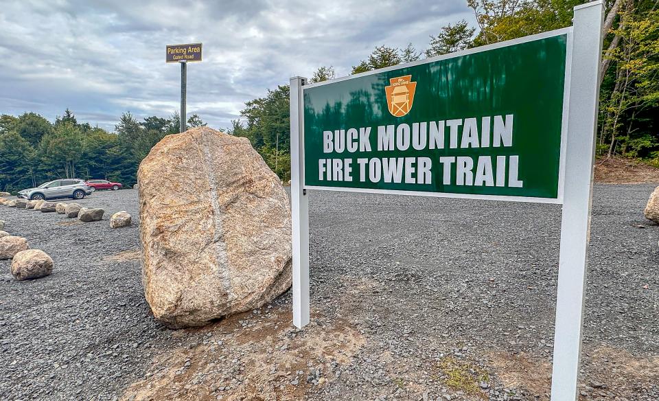 A sign at the parking lot for a hiking trail.