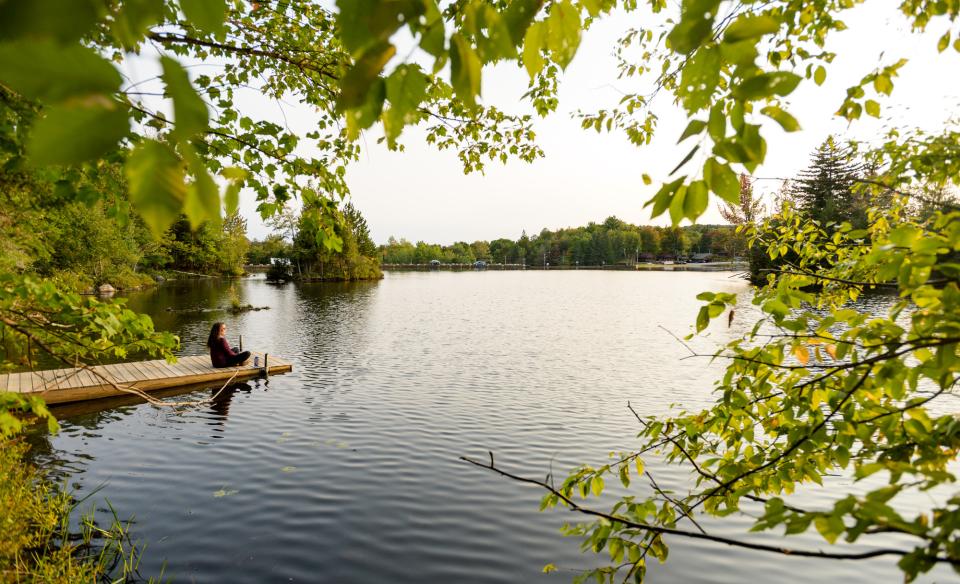 A woman sits on a dock