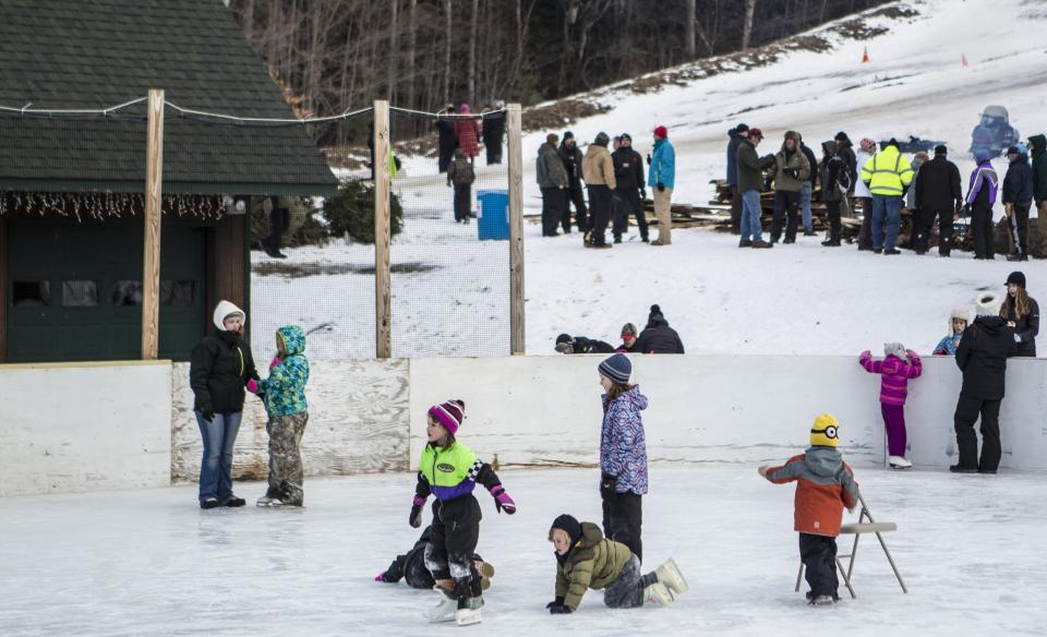 Ice skating by a sledding hill