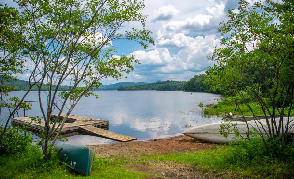 A U-shaped dock in a lake by a campsite