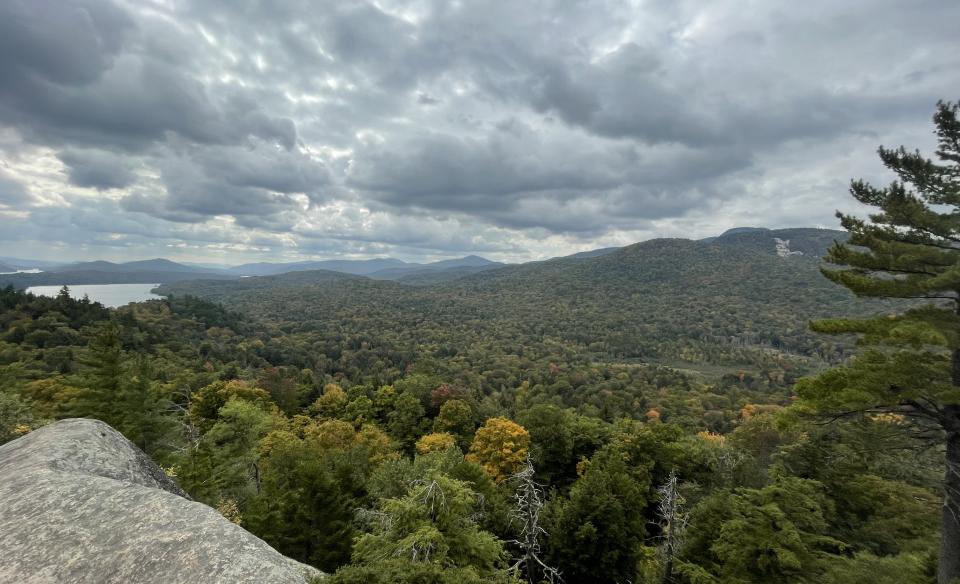 An expansive view of mountains and Indian Lake seen from Watch Hill.