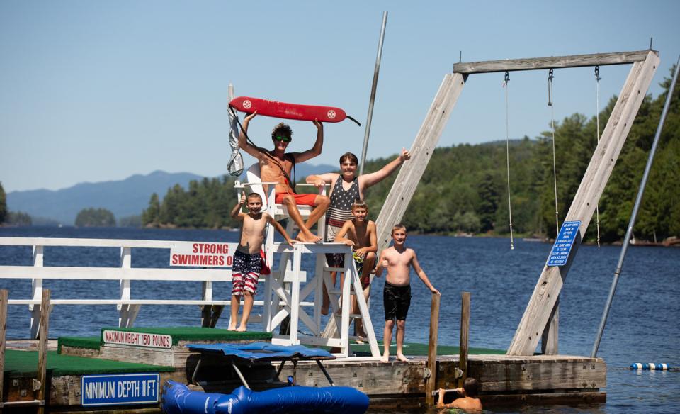 Some kids with a lifeguard on a floating dock in Long Lake.