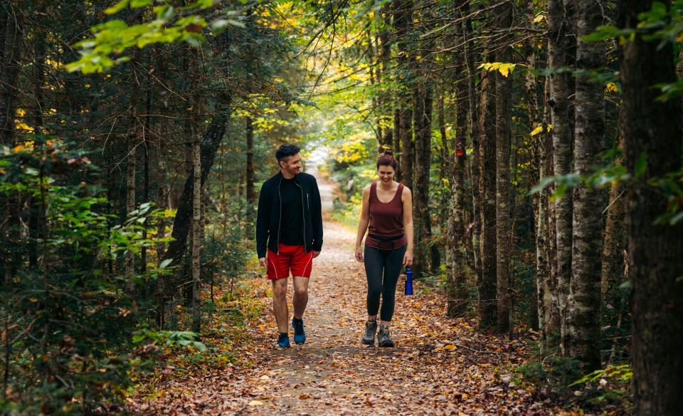 A couple walking along a flat trail during fall